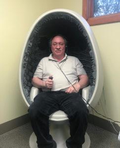 man sitting in egg chair