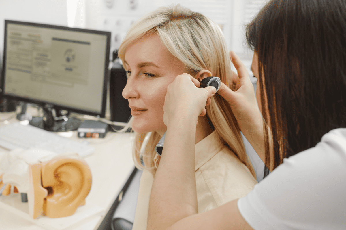 A Woman is having her hearing evaluated.
